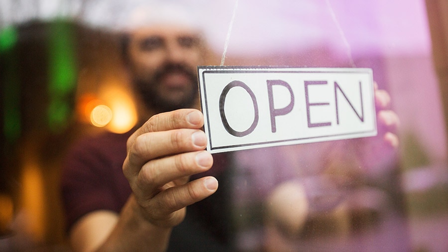 Man with open banner at bar or restaurant window