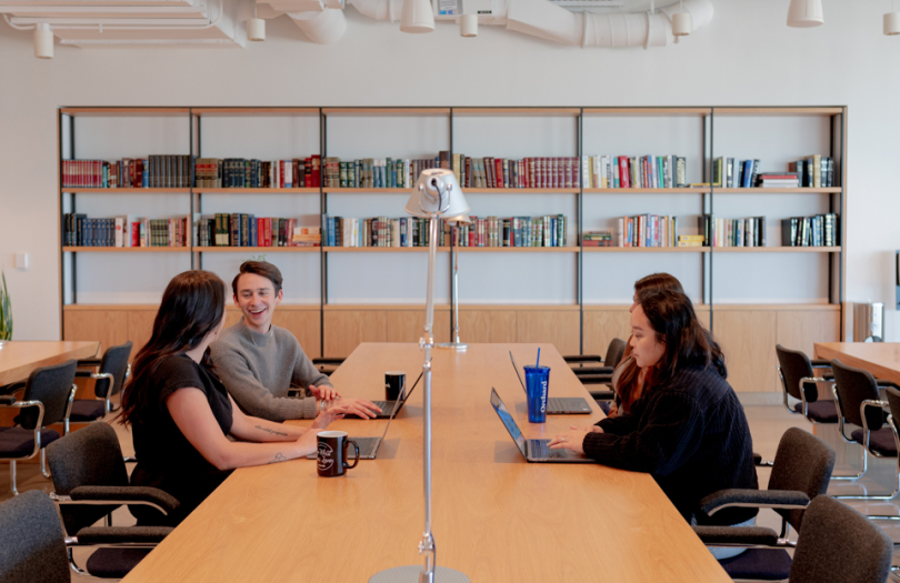 Four Orchard employees working in our Austin office lounge at the study desks