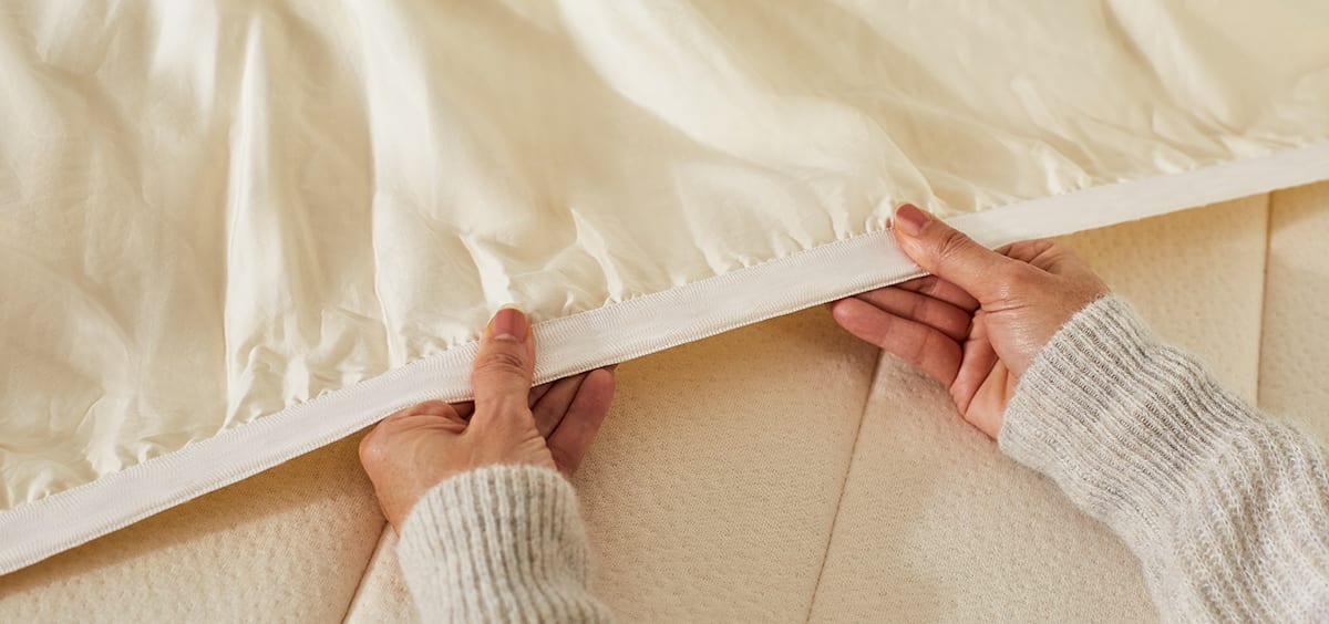 putting Birch mattress pad on a mattress