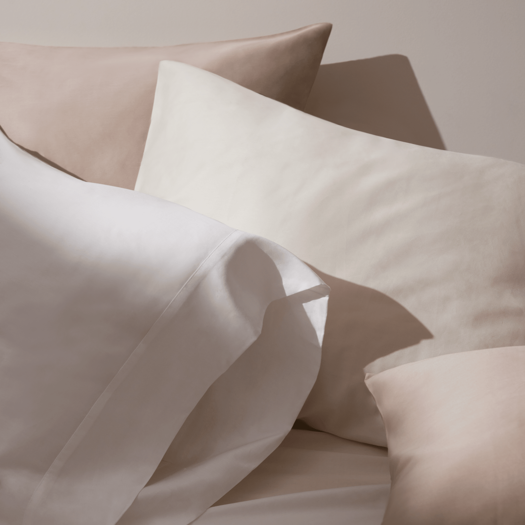 Sheets in white, sand, and beige