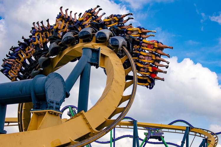 people riding a roller coaster at six flags over texas