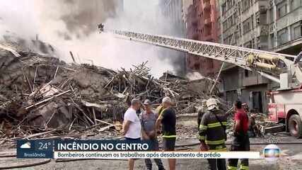 Bombeiros tentam apagar incêndio nos escombros de prédio que desabou