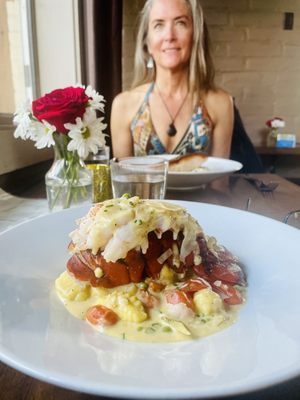 Photo of ROUX - Carmel Valley, CA, US. a woman sitting at a table with a plate of food