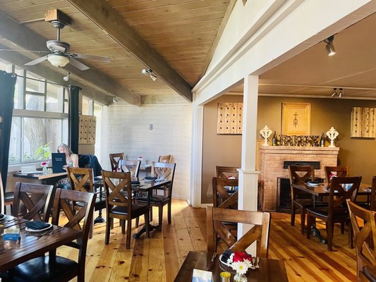 Photo of ROUX - Carmel Valley, CA, US. a dining room with wooden tables and chairs