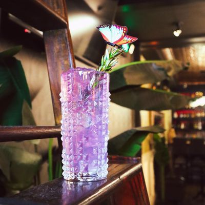 Photo of Dahlia Lounge - San Francisco, CA, US. a purple glass with a flower in it