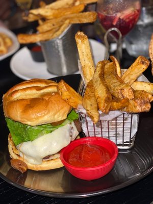 Photo of ININE Bistro - New York, NY, US. a burger and fries on a plate