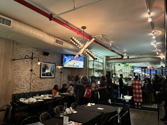 Photo of Row House - New York, NY, US. people sitting at tables in a restaurant