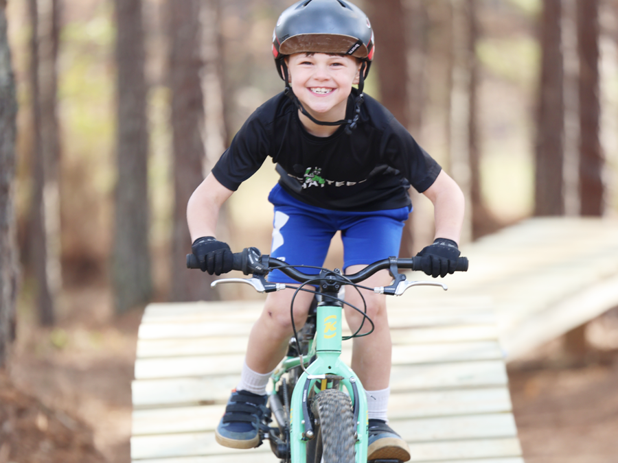 boy riding a bike on trail