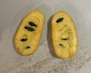 Longi-section through fruit: yellow flesh and large black seeds