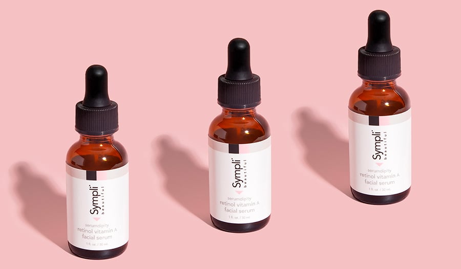 Retinol serum bottles on pink background