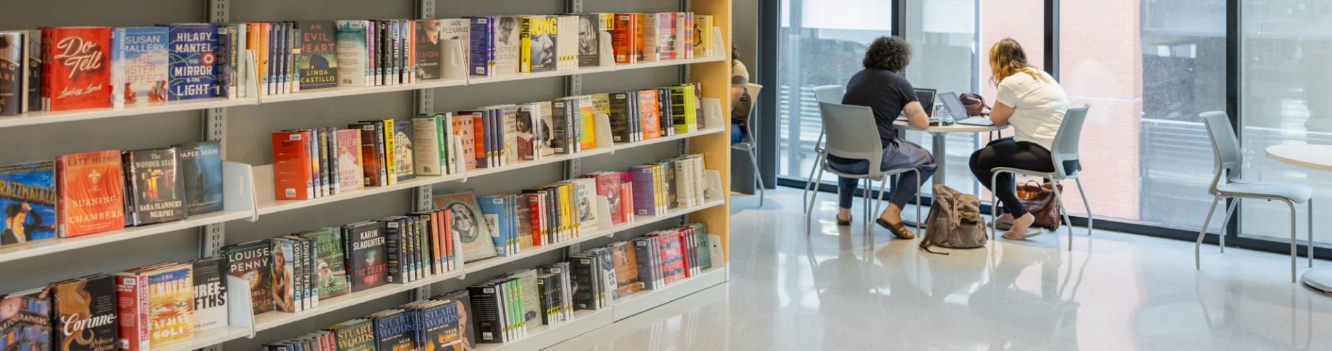 bookshelves and people sitting at table