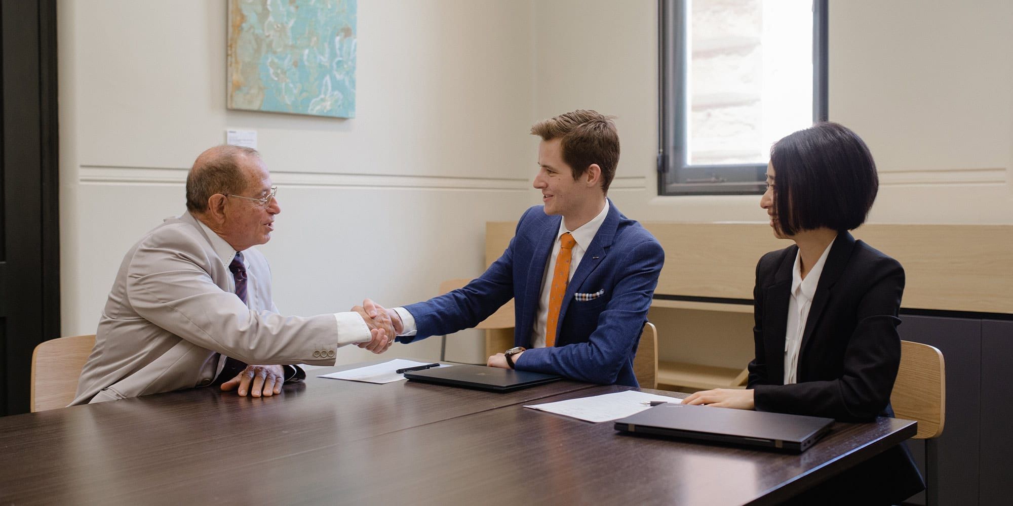 Curtin law students shaking hands with lawyer