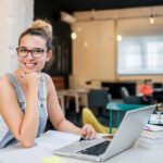 Portrait of smiling entrepreneur girl indoors.