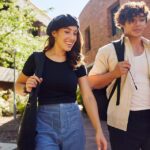 Male and female student walking through Bentley Campus