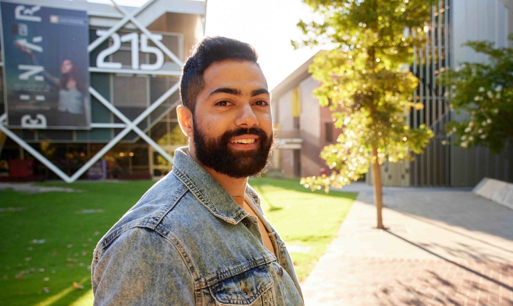 student smiling in front of engineering building