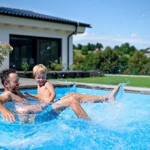 Father and son playing in the swimming pool