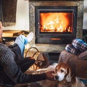 Father with son sitting near fireplace