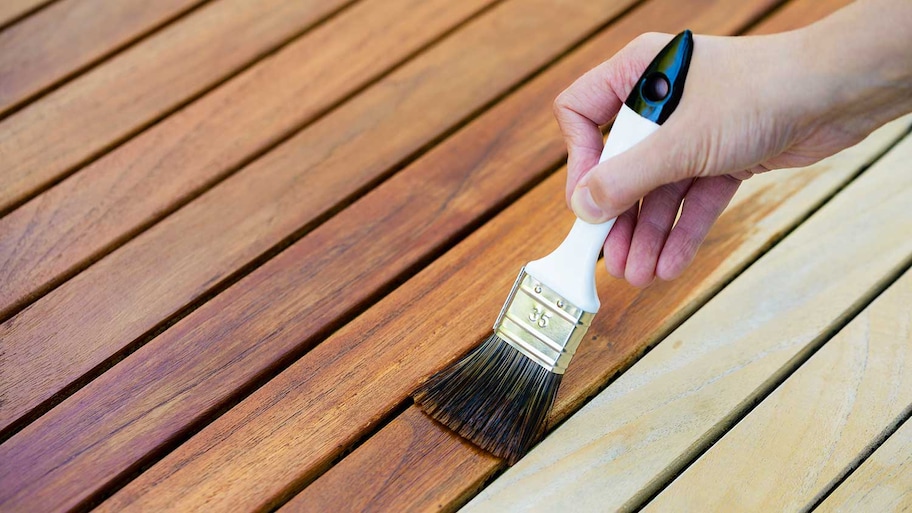 Applying varnish to a table with a brush