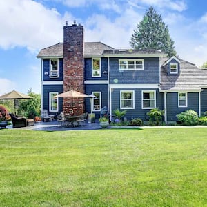 Blue house with chimney and big yard