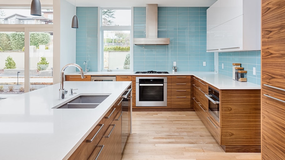 A kitchen with blue subway tiles for backsplash