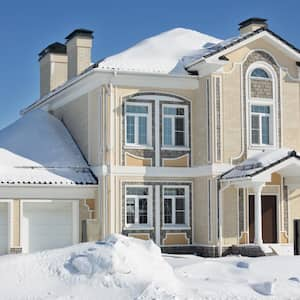 Light cottage with garage at frosty and sunny winter