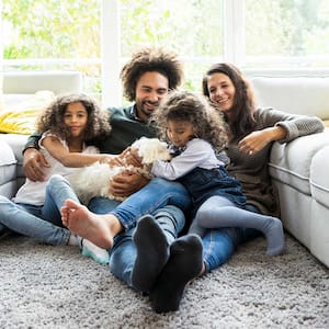 Family lounging on carpet