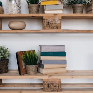 Floating pallet shelves with books and plants on them