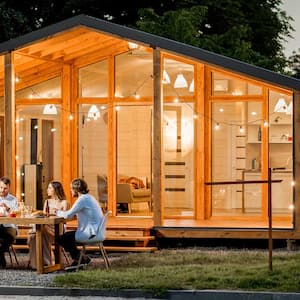 Friends dining on a house patio at night