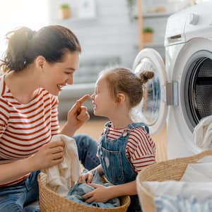 Mom and daughter doing laundry together