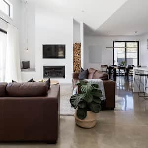 A living room with polished concrete floor