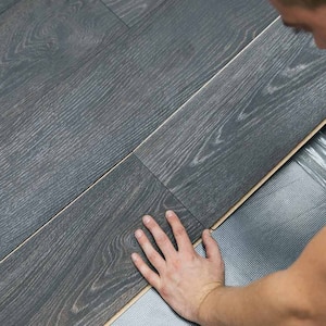 man installing laminate floor