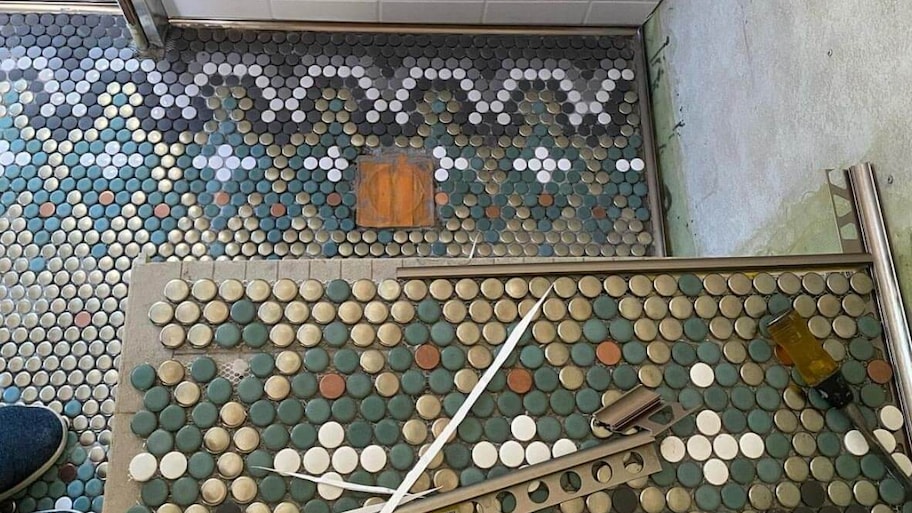 Metallic penny tiles used for flooring in a bathroom