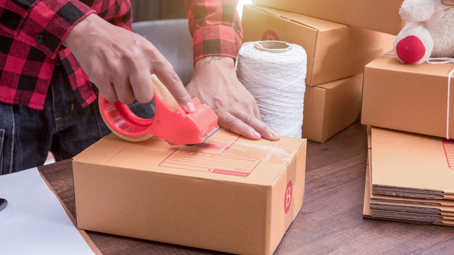 Using tape to pack cardboard boxes