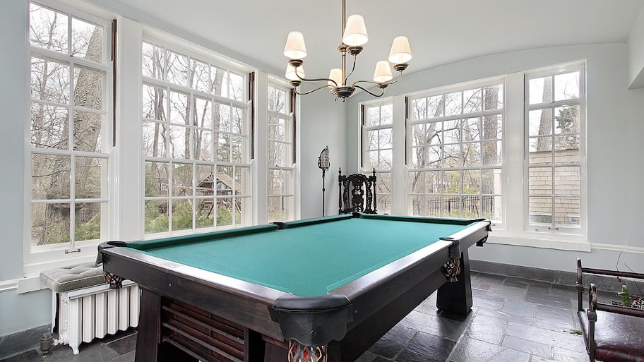 A pool room with wall of windows