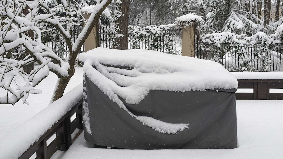 Cover protecting patio furniture from snow