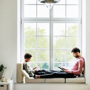 Father and son relaxing by the window
