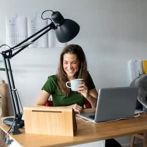 A smiling woman holding a mug