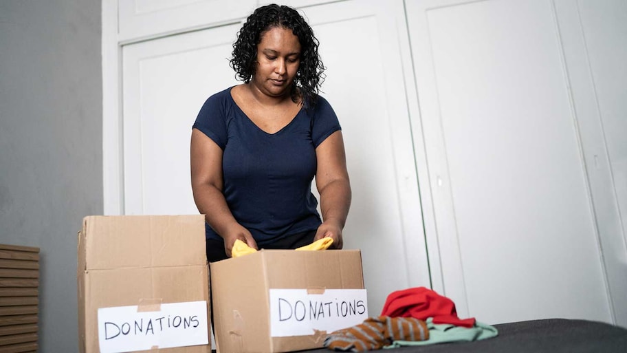 Woman sorting out clothes for donation