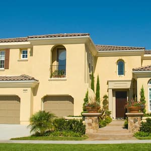 Two story stucco house with garage