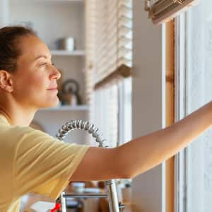 A woman cleaning window