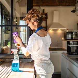 woman cleaning her apartment windows