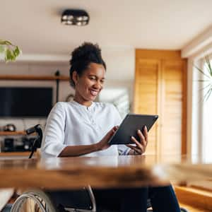 A woman reading on her tablet at home