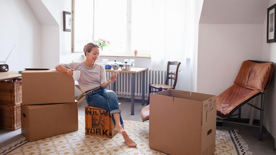 A woman taking a coffee break while moving house