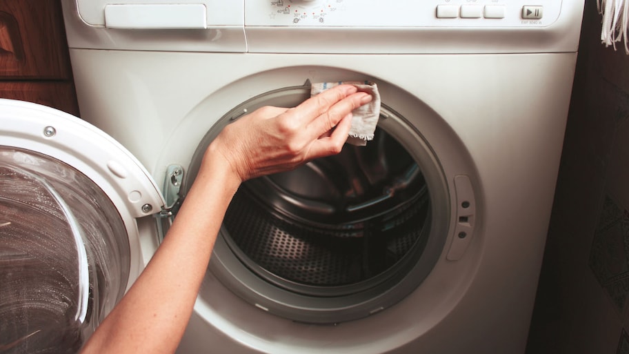 woman cleaning dryer machine