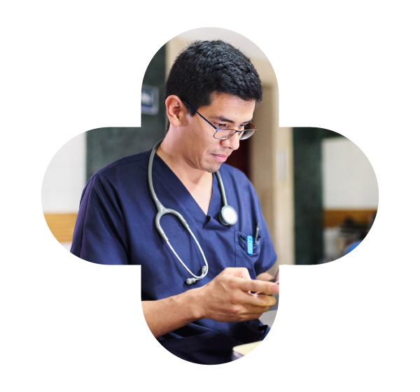 Healthcare professional with a stethoscope looking at his phone