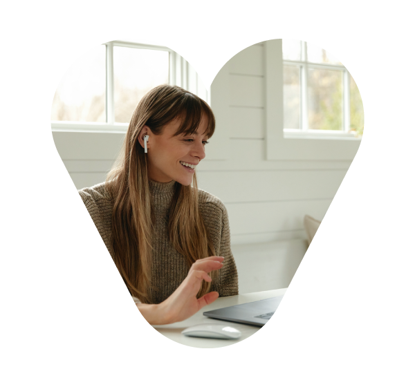 Lady at viewing a laptop with earbuds