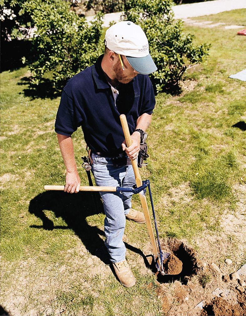 a man digging a posthole