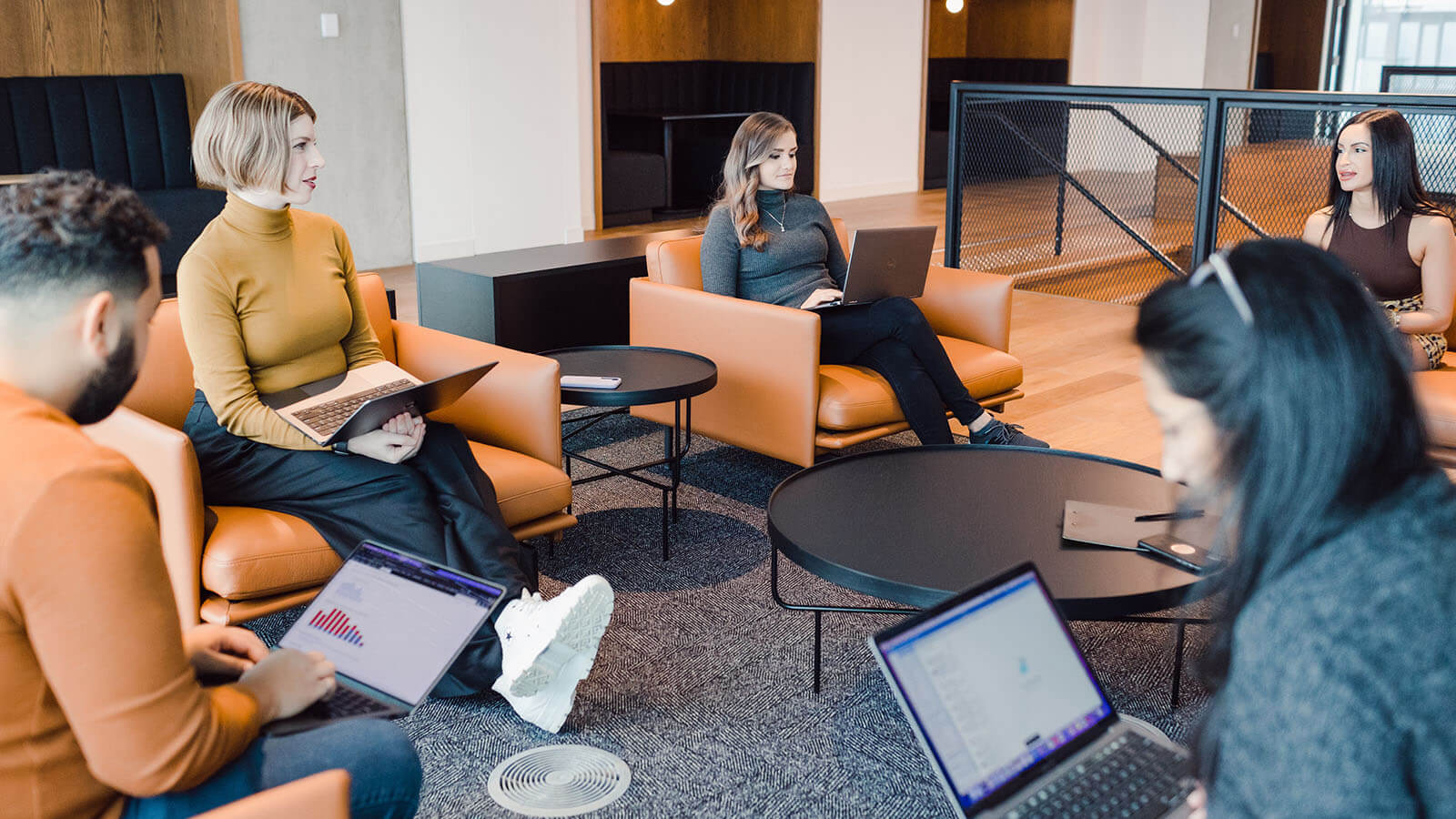 Colleagues meeting with laptops