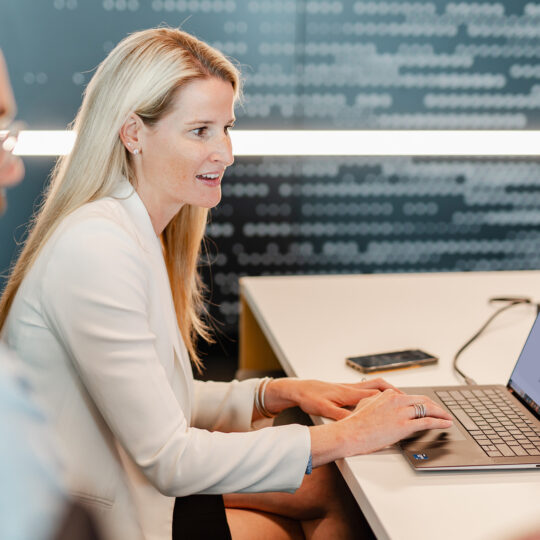 Colleagues working around a laptop