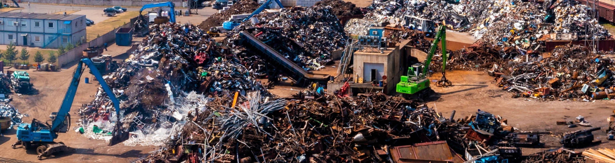 Scrap Yard With Pile Of Crushed Cars. Old damaged cars on the junkyard waiting for recycling